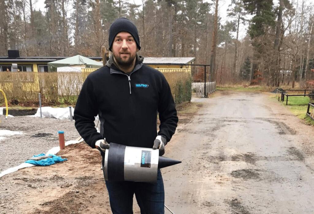Peter Olsson of Wapro holding a WaStop® check valve outside a home
