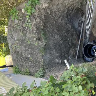 waback-access-installation-behind-boulder-flood-prevention-enskede-us WaBack check valve installed behind a boulder to prevent basement flooding in Enskede