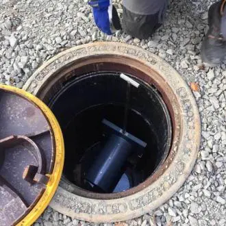 wapro-access-check-valve-installation-dn200-prevent-sewer-backflow-flood-maintenance-kristianstad-us WaStop DN200 access check valve being installed in sewer chamber to prevent backflow and allow easy maintenance