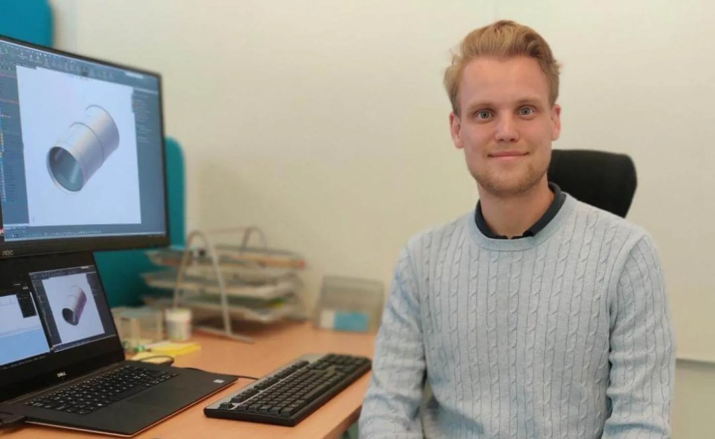 Fredrik from Wapro technical support at his desk, with a 3D CAD model of a valve on the monitors beside him